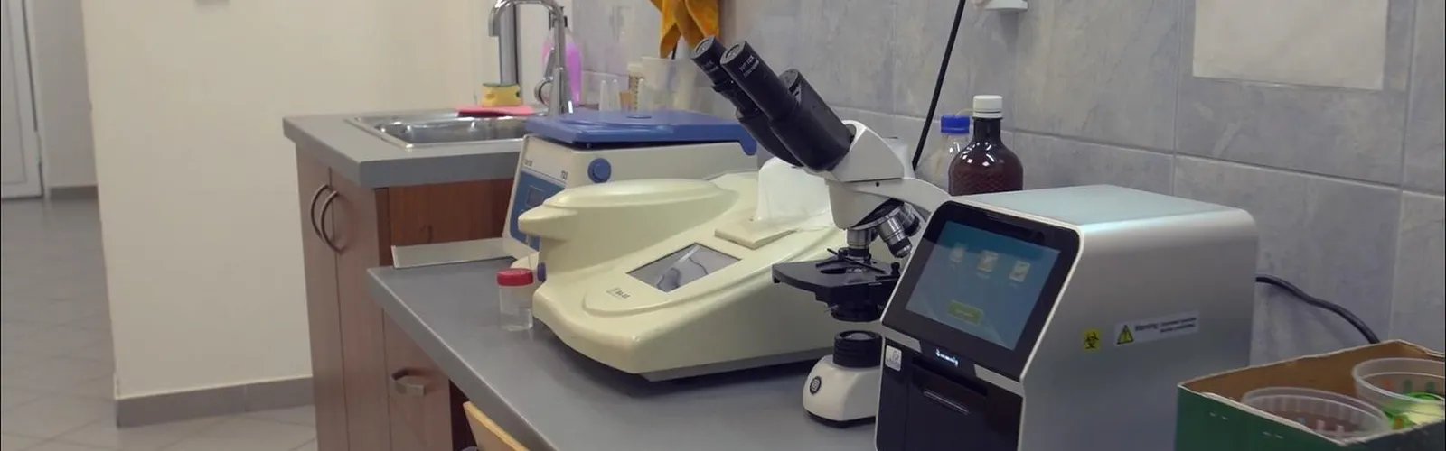 Veterinary diagnostics — a veterinary clinic laboratory with analysers, a centrifuge and a microscope